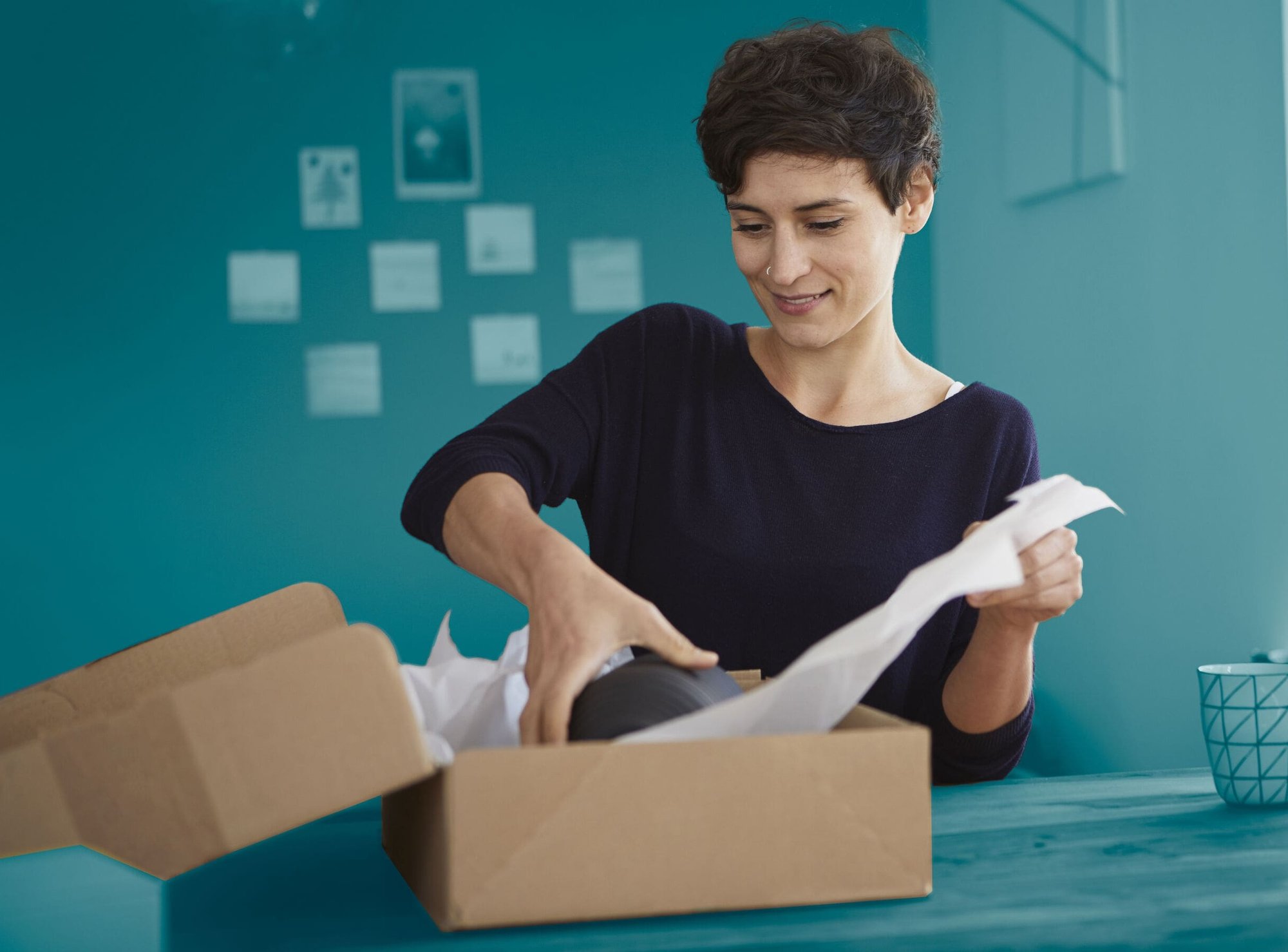 Mujer sosteniendo paquete de devolución e-PAQ Returns - Asendia
